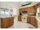 Kitchen with wood cabinets, light countertops, and stainless steel appliances at 385 Pelican Bnd, Placida, FL 33946
