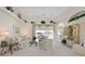 Relaxing living room featuring plush carpet, large windows with pool views, and ceiling fan at 385 Pelican Bnd, Placida, FL 33946