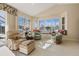 Living room with large windows, a built-in window seat, and views of the water at 385 Pelican Bnd, Placida, FL 33946