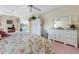 Main bedroom featuring white furniture, floral patterns, and pool views at 385 Pelican Bnd, Placida, FL 33946