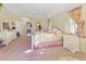 Spacious main bedroom with pink carpet, white furniture, and floral patterns at 385 Pelican Bnd, Placida, FL 33946