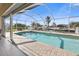 Pool and patio area with waterfront views and lush landscaping at 385 Pelican Bnd, Placida, FL 33946