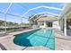 Inviting pool with a screened enclosure and brick patio surround at 385 Pelican Bnd, Placida, FL 33946