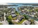 Picturesque waterfront home showcasing its dock, lush lawn, and surrounding community at 385 Pelican Bnd, Placida, FL 33946