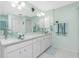 Double vanity bathroom with glass sinks and light green walls at 409 Boundary Blvd, Rotonda West, FL 33947