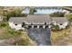 Aerial view of a condo building near a lake, showing its layout and surroundings at 4260 Placida Rd # 14C, Englewood, FL 34224