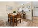 Dining area with a wooden table and chairs, located near a kitchen breakfast bar at 4260 Placida Rd # 14C, Englewood, FL 34224