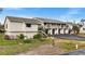 Condo building exterior, featuring multiple units, individual garages, and landscaping at 4260 Placida Rd # 14C, Englewood, FL 34224