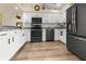 Modern kitchen with granite countertops, stainless steel appliances, and wood-look flooring at 4260 Placida Rd # 14C, Englewood, FL 34224