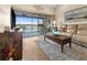 Living room featuring a comfortable sofa, coffee table and sliding glass doors to a balcony with water views at 4260 Placida Rd # 14C, Englewood, FL 34224