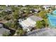 Community pool with lounge chairs and tennis courts at 4260 Placida Rd # 14C, Englewood, FL 34224