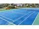 Tennis court with green perimeter and blue playing surface at 4260 Placida Rd # 14C, Englewood, FL 34224