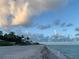 Stunning beach view with soft sand and clear water under a bright sky at 4656 Pompano St, Placida, FL 33946