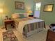 Bedroom with striped bedding and a view of tropical foliage at 4656 Pompano St, Placida, FL 33946