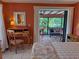 Bedroom with patio doors leading to a relaxing screened porch at 4656 Pompano St, Placida, FL 33946
