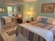 Bedroom with striped bedding and mirrored closet doors at 4656 Pompano St, Placida, FL 33946