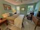Bedroom with striped bedding and a relaxing armchair at 4656 Pompano St, Placida, FL 33946