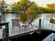 Relaxing waterfront dock with seating, offering peaceful water views at 4656 Pompano St, Placida, FL 33946
