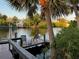 Charming waterfront dock with seating, overlooking a tranquil canal at 4656 Pompano St, Placida, FL 33946