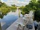 Enjoy serene canal views from this waterfront dock with comfortable seating at 4656 Pompano St, Placida, FL 33946