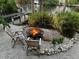 Charming fire pit area with two wooden chairs, perfect for outdoor gatherings at 4656 Pompano St, Placida, FL 33946