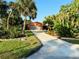 Single story home with a long driveway and lush landscaping at 4656 Pompano St, Placida, FL 33946