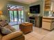 Living area with a view of the pool and patio through sliding doors at 4656 Pompano St, Placida, FL 33946