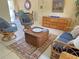 Relaxing living room featuring rattan furniture and a colorful rug at 4656 Pompano St, Placida, FL 33946