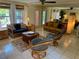 Bright and airy living room with wicker furniture and large windows at 4656 Pompano St, Placida, FL 33946