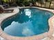 Inviting kidney-shaped pool with mosaic tile and spacious patio at 4656 Pompano St, Placida, FL 33946