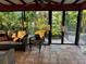 Relaxing sunroom with wicker furniture, tiled floors, and scenic water views at 4656 Pompano St, Placida, FL 33946