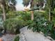 Landscaped waterfront pathway leading to canal views at 4656 Pompano St, Placida, FL 33946