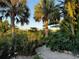 Lush tropical landscaping and serene canal views at 4656 Pompano St, Placida, FL 33946