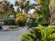 Landscaped backyard with a view of the canal and a docked boat at 4656 Pompano St, Placida, FL 33946