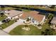 An aerial view of a waterfront home with covered patio and lush lawn at 47 Sportsman Ln, Rotonda West, FL 33947