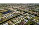 An aerial perspective of homes with pools, canals, and lush green lawns at 47 Sportsman Ln, Rotonda West, FL 33947