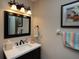 Bathroom with a white vanity, dark wood cabinets, and modern fixtures at 47 Sportsman Ln, Rotonda West, FL 33947