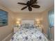 Relaxing bedroom with coastal decor, white headboard, matching nightstands, and ceiling fan at 47 Sportsman Ln, Rotonda West, FL 33947