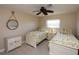 Bedroom with two twin beds, white furniture, and beach-themed decor at 47 Sportsman Ln, Rotonda West, FL 33947