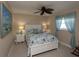 Coastal-themed bedroom with white furniture, blue accents, and a ceiling fan at 47 Sportsman Ln, Rotonda West, FL 33947