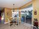 Dining area with pool views through large sliding glass doors at 47 Sportsman Ln, Rotonda West, FL 33947