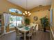 Dining room with vaulted ceilings, large windows, and a chandelier at 47 Sportsman Ln, Rotonda West, FL 33947