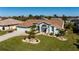 Charming light blue single-story home with a landscaped front yard at 47 Sportsman Ln, Rotonda West, FL 33947