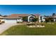Charming single-story home with a well-maintained lawn, landscaping, and a two-car garage at 47 Sportsman Ln, Rotonda West, FL 33947