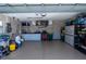 Two-car garage with epoxy flooring, storage cabinets, and utility sink at 47 Sportsman Ln, Rotonda West, FL 33947