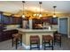 Kitchen with breakfast bar, pendant lights, granite countertop, and dark cabinets at 47 Sportsman Ln, Rotonda West, FL 33947