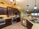 Open kitchen with dark wood cabinets, stainless steel appliances, and granite countertops at 47 Sportsman Ln, Rotonda West, FL 33947