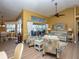 Living area with patterned armchairs, couch, and sliding glass doors leading to the outdoors at 47 Sportsman Ln, Rotonda West, FL 33947