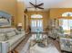 Living room with light gray couches, decorative rug, and front door entrance at 47 Sportsman Ln, Rotonda West, FL 33947