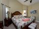 Large main bedroom with wooden furniture, lots of natural light, and high ceilings at 47 Sportsman Ln, Rotonda West, FL 33947